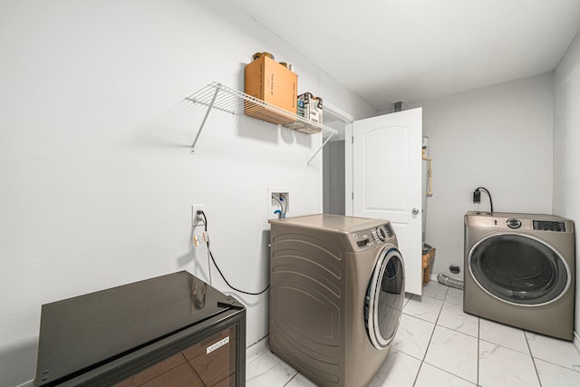 laundry area with light marble finish flooring and washing machine and clothes dryer