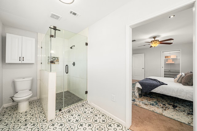 ensuite bathroom with baseboards, a ceiling fan, toilet, a stall shower, and recessed lighting