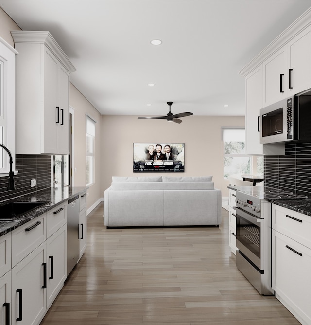 kitchen with appliances with stainless steel finishes, a sink, a ceiling fan, decorative backsplash, and recessed lighting