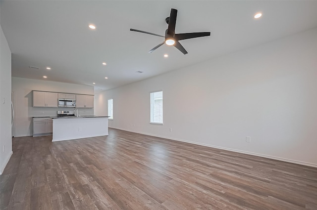 5422 Evergreen Heights Ln, Spring, TX 77373 - unfurnished living room with recessed lighting, wood finished floors, a ceiling fan, baseboards, and a sink