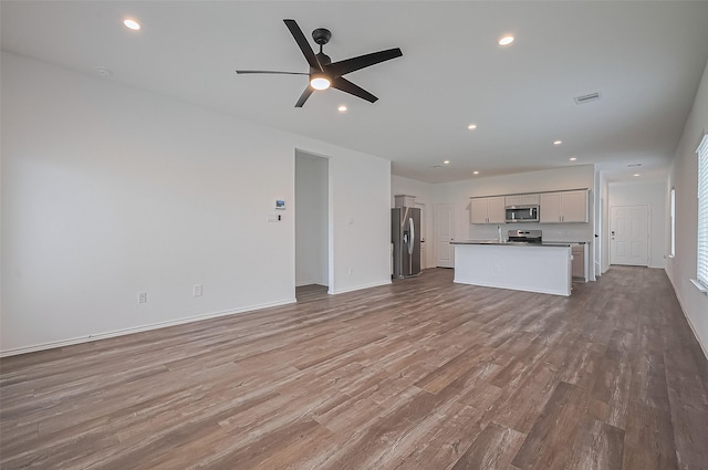 5422 Evergreen Heights Ln, Spring, TX 77373 - unfurnished living room with wood finished floors, ceiling fan, recessed lighting, and baseboards