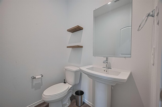 5422 Evergreen Heights Ln, Spring, TX 77373 - bathroom with toilet, wood finished floors, and baseboards