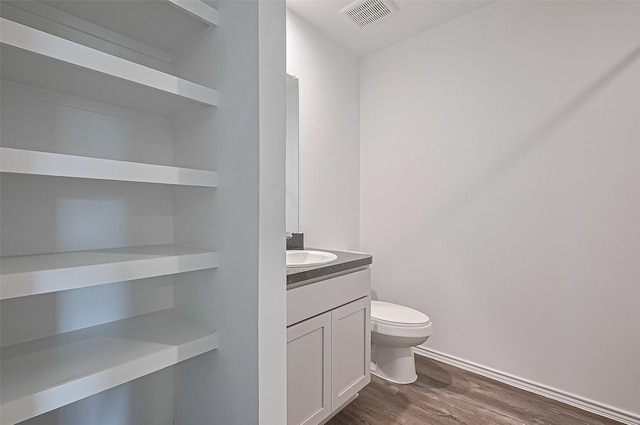 5422 Evergreen Heights Ln, Spring, TX 77373 - half bathroom with toilet, wood finished floors, vanity, and baseboards