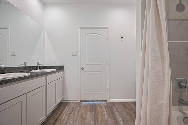 5422 Evergreen Heights Ln, Spring, TX 77373 - full bath with wood finished floors, double vanity, baseboards, and shower / bath combo with shower curtain