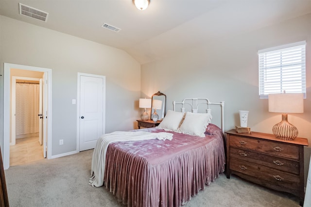bedroom with light carpet, lofted ceiling, and baseboards