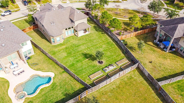 aerial view of property and surrounding area featuring a pool area