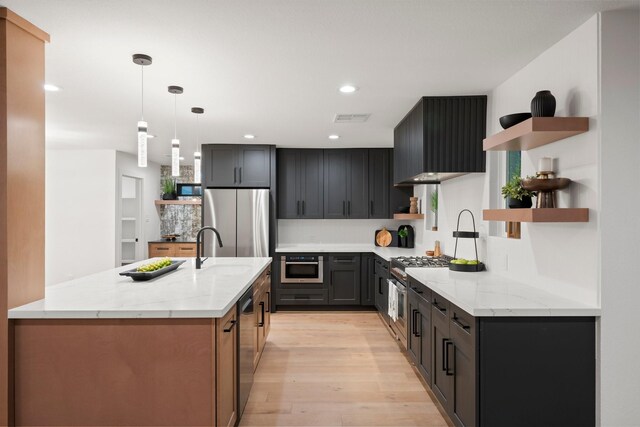 kitchen with open shelves, light wood-style flooring, light stone countertops, a sink, and stainless steel appliances