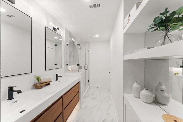 full bathroom with marble look tiles, a marble finish shower, double vanity, and recessed lighting