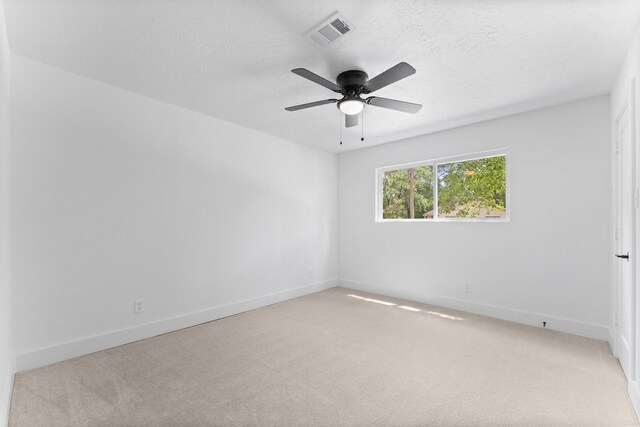 2003 Longstraw Pl, The Woodlands, TX 77380 - spare room featuring light colored carpet, baseboards, ceiling fan, and a textured ceiling