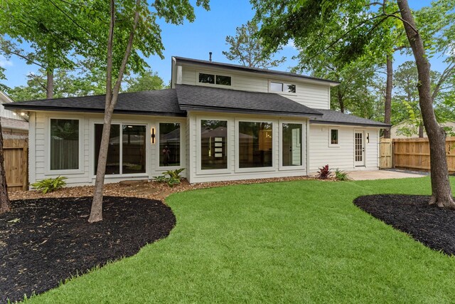 back of house featuring roof with shingles and a patio