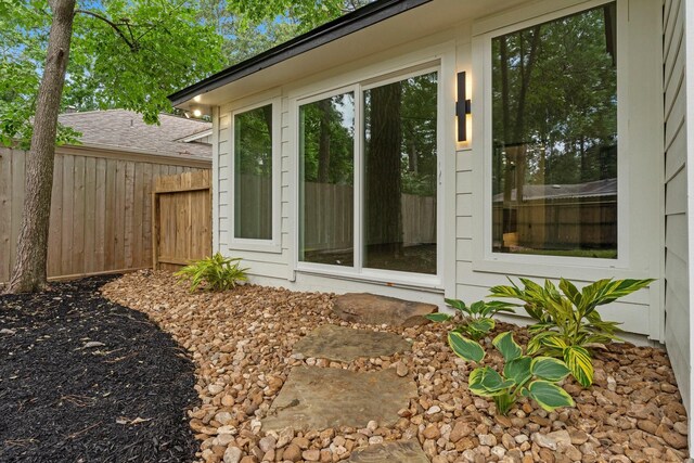 doorway to property featuring fence