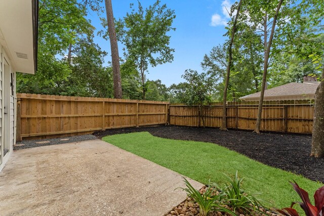 fenced backyard featuring a patio area