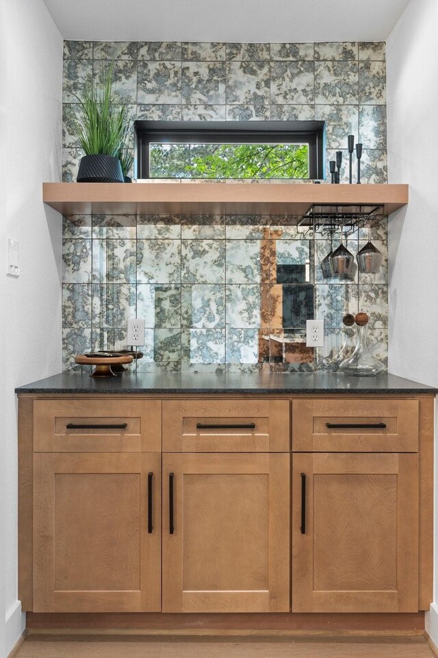 indoor dry bar featuring decorative backsplash