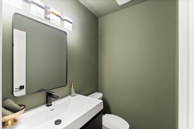 bathroom with toilet and vanity