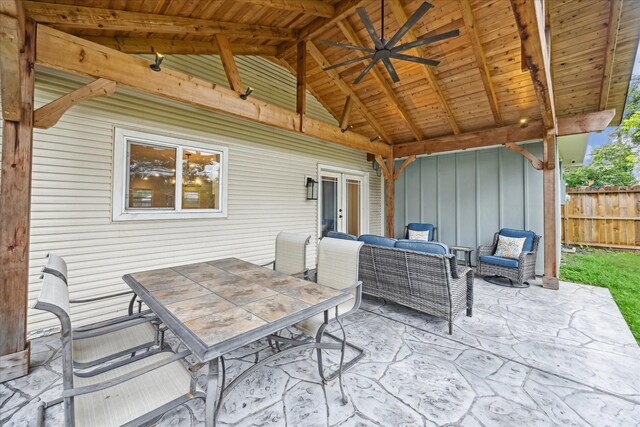 view of patio / terrace featuring fence, an outdoor living space, outdoor dining space, and french doors
