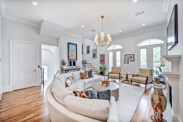 7119 Janet St, Houston, TX 77055 - living room featuring light wood-style floors, a chandelier, recessed lighting, crown molding, and french doors