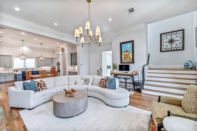 7119 Janet St, Houston, TX 77055 - living room with a chandelier, wood finished floors, recessed lighting, ornamental molding, and stairway