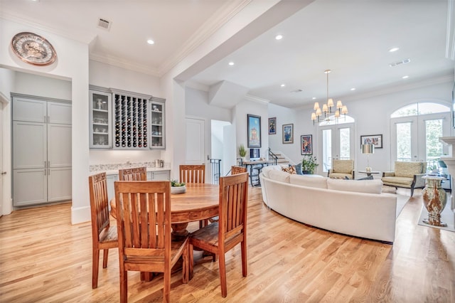 7119 Janet St, Houston, TX 77055 - dining room with light wood-style floors, recessed lighting, stairway, crown molding, and a chandelier