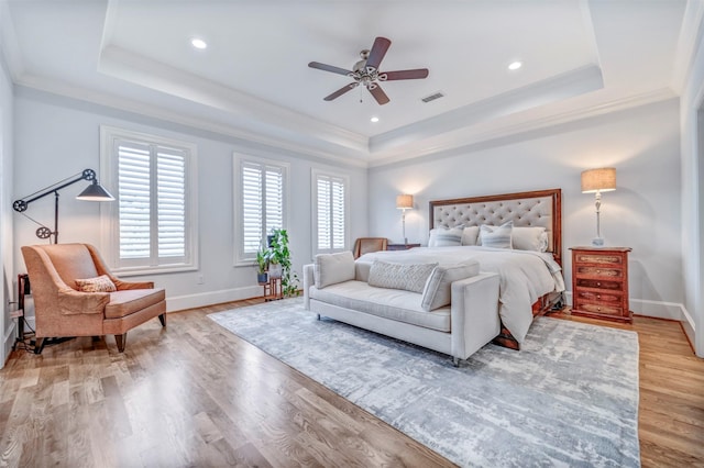 7119 Janet St, Houston, TX 77055 - bedroom featuring a raised ceiling, crown molding, baseboards, light wood-type flooring, and a ceiling fan