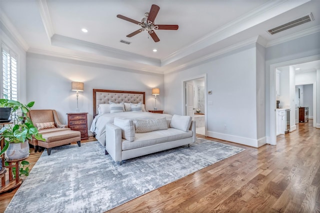 7119 Janet St, Houston, TX 77055 - bedroom with wood finished floors, a tray ceiling, baseboards, ornamental molding, and recessed lighting