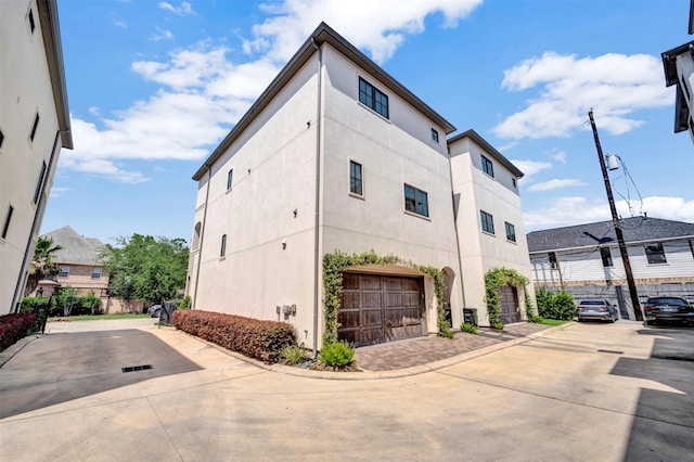 7119 Janet St, Houston, TX 77055 - view of building exterior featuring an attached garage and driveway