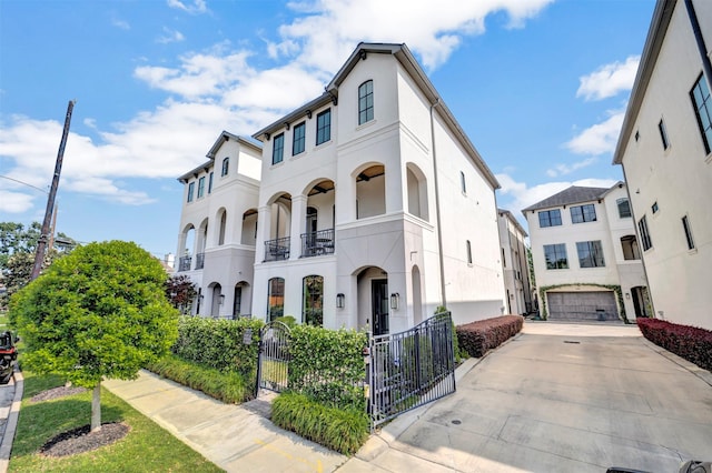 7119 Janet St, Houston, TX 77055 - view of front of house featuring a gate, a balcony, and stucco siding
