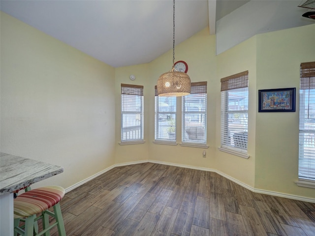 13558 Peseta Ct, Corpus Christi, TX 78418 - unfurnished dining area featuring wood finished floors, baseboards, and high vaulted ceiling