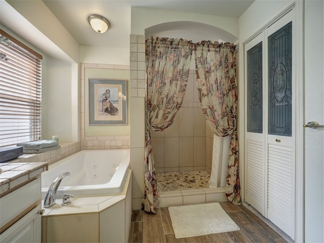 13558 Peseta Ct, Corpus Christi, TX 78418 - full bath featuring a whirlpool tub, wood finished floors, a shower stall, and vanity