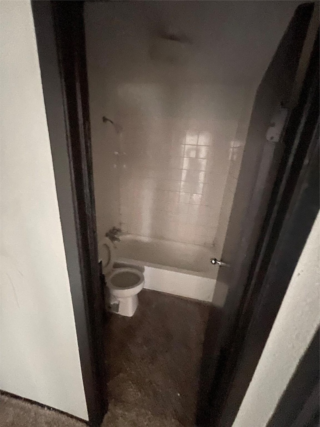 bathroom with toilet and bathing tub / shower combination
