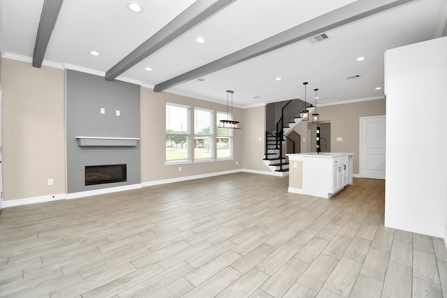 8103 Venus Dr, Houston, TX 77088 - unfurnished living room with beam ceiling, stairway, a glass covered fireplace, baseboards, and a sink