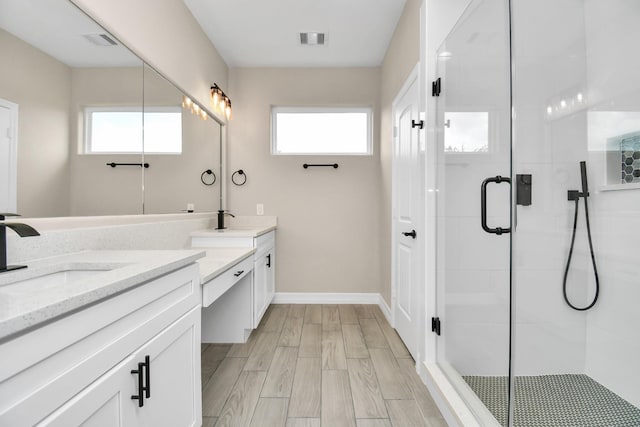 8103 Venus Dr, Houston, TX 77088 - full bath featuring a stall shower, healthy amount of natural light, vanity, and wood finished floors