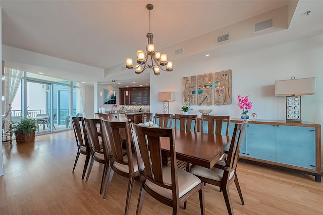 801 E Beach Dr Unit Tw2008, Galveston, TX 77550 - dining area with light wood-style flooring, a chandelier, recessed lighting, and floor to ceiling windows