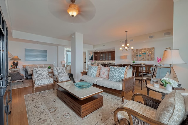 801 E Beach Dr Unit Tw2008, Galveston, TX 77550 - living room featuring a chandelier, wood finished floors, and a ceiling fan