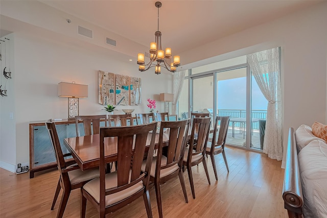 801 E Beach Dr Unit Tw2008, Galveston, TX 77550 - dining space with light wood-style flooring and a chandelier