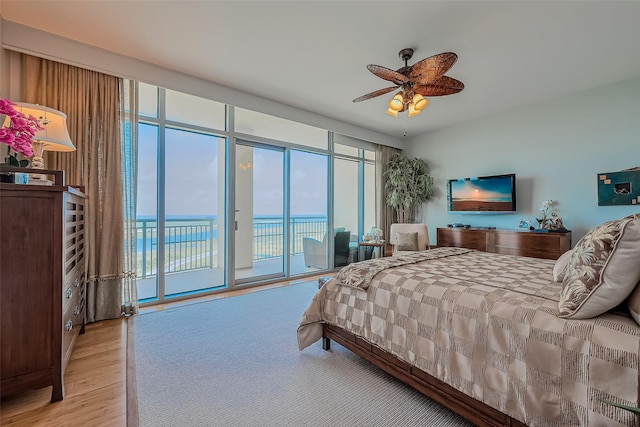 801 E Beach Dr Unit Tw2008, Galveston, TX 77550 - bedroom featuring access to exterior, wood finished floors, and a ceiling fan
