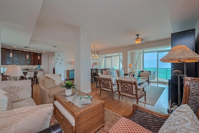801 E Beach Dr Unit Tw2008, Galveston, TX 77550 - living room with a chandelier, wood finished floors, and a ceiling fan