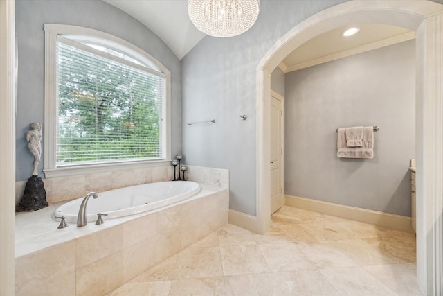 bathroom featuring a garden tub, a chandelier, baseboards, and vaulted ceiling