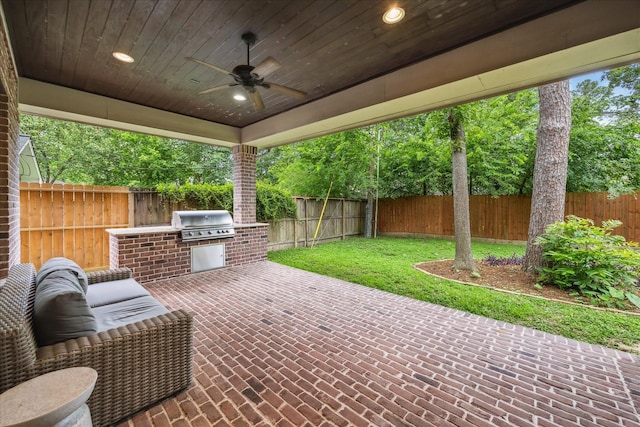 view of patio with ceiling fan, an outdoor kitchen, and area for grilling