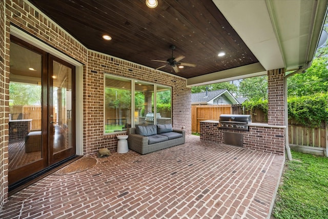 view of patio / terrace featuring grilling area, french doors, an outdoor kitchen, and fence