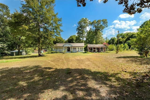 view of grassy yard featuring a porch
