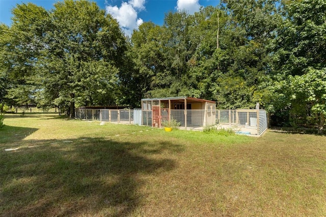 view of yard featuring an outdoor structure and an exterior structure