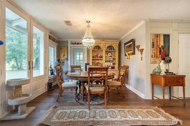 dining area with dark wood finished floors, a chandelier, ornamental molding, french doors, and baseboards