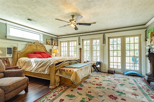 bedroom featuring access to outside, wood finished floors, crown molding, a textured ceiling, and a ceiling fan
