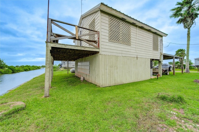 1577 Channel Dr, Brazoria, TX 77422 - view of side of property featuring a yard and a deck with water view