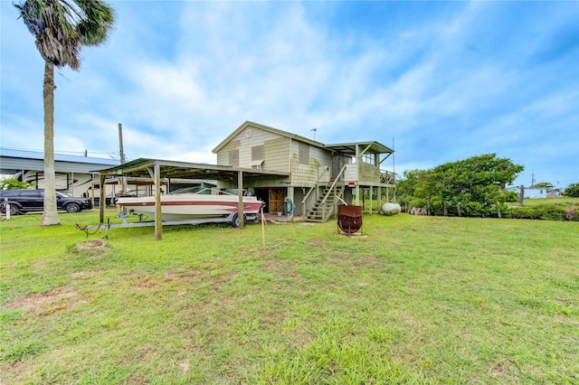 1577 Channel Dr, Brazoria, TX 77422 - rear view of house with a yard and stairs