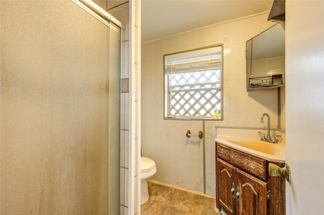 1577 Channel Dr, Brazoria, TX 77422 - full bath with a stall shower, toilet, vanity, and tile walls