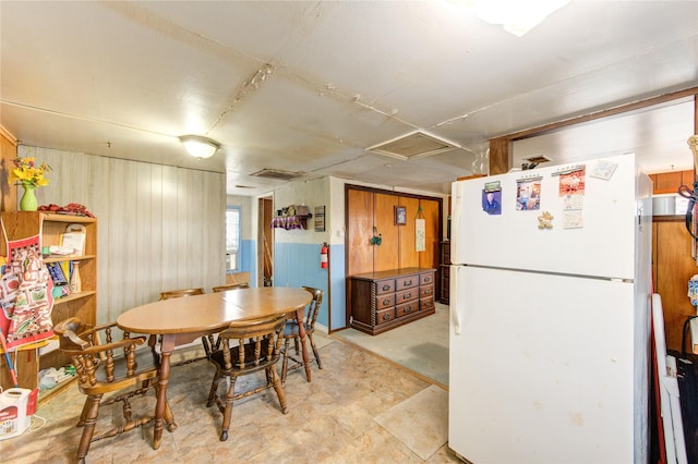 1577 Channel Dr, Brazoria, TX 77422 - dining area featuring wooden walls, attic access, and light flooring