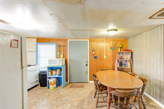 1577 Channel Dr, Brazoria, TX 77422 - dining area with wooden walls and tile patterned floors