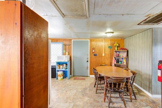 1577 Channel Dr, Brazoria, TX 77422 - dining room featuring wood walls, light floors, and baseboards