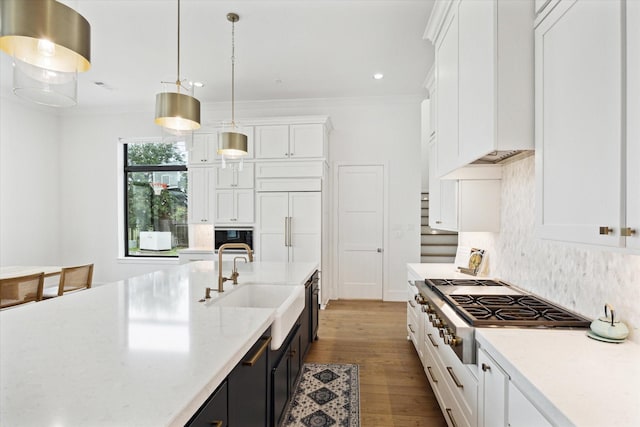 13611 Milan Meadow Ct, Houston, TX 77077 - kitchen with stainless steel gas stovetop, a sink, white cabinets, backsplash, and ornamental molding